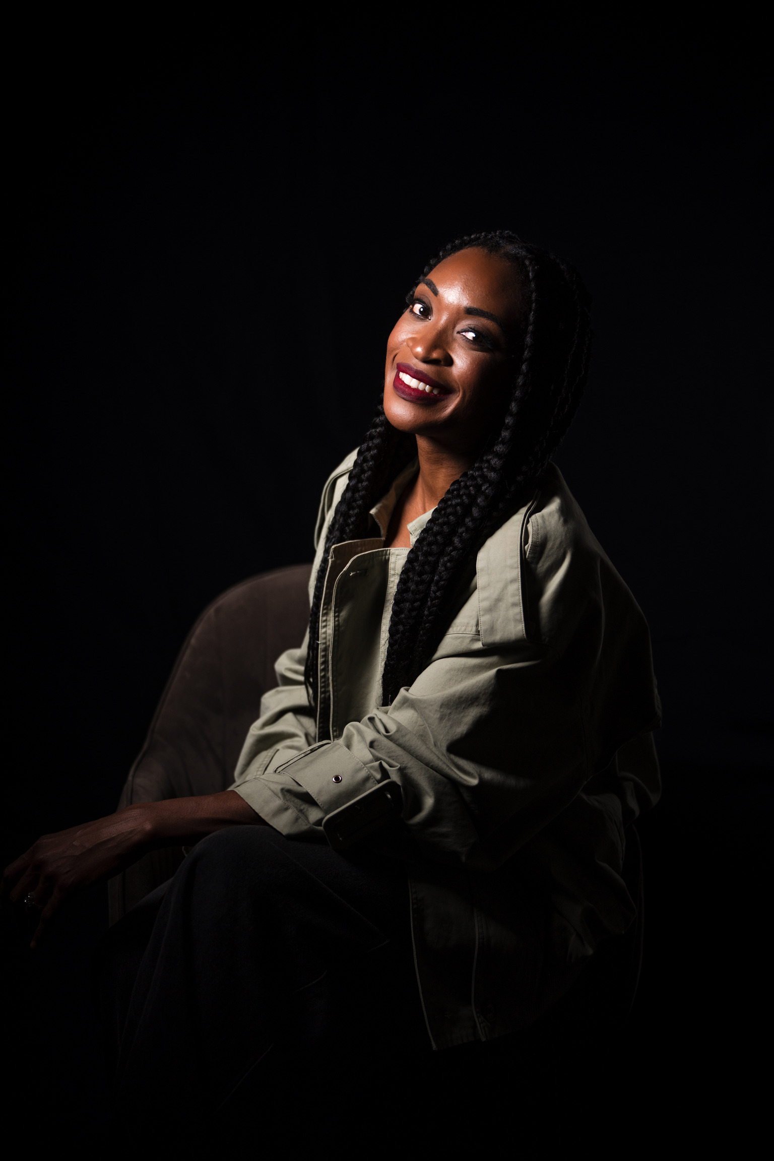 Nkechi Vaughn seated in a khaki jacket
